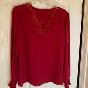 Red blouse with lace V-neck and smocking at the cuffs. Perfect for the holidays!